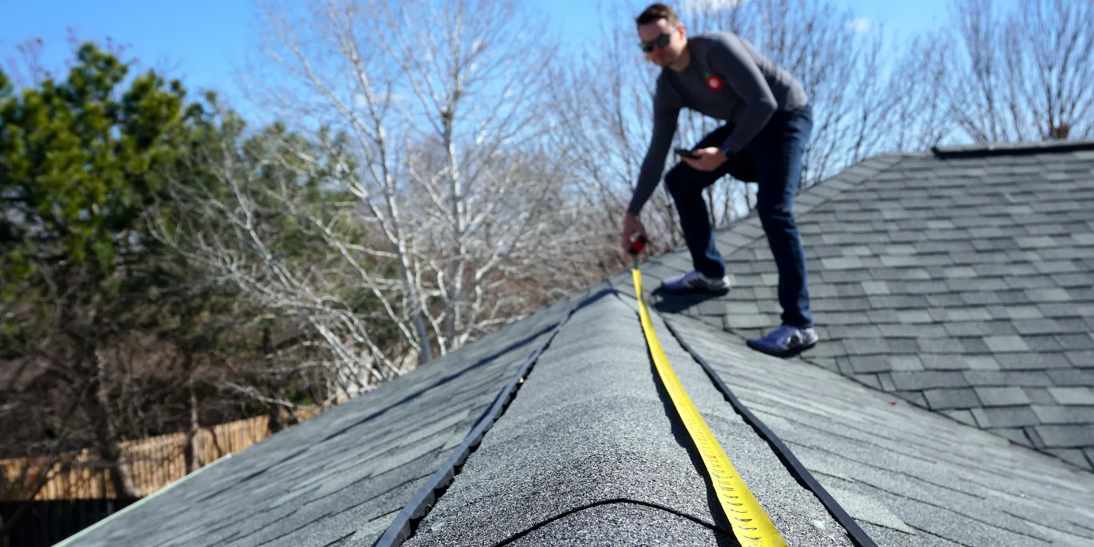 Professional roofer working on a property